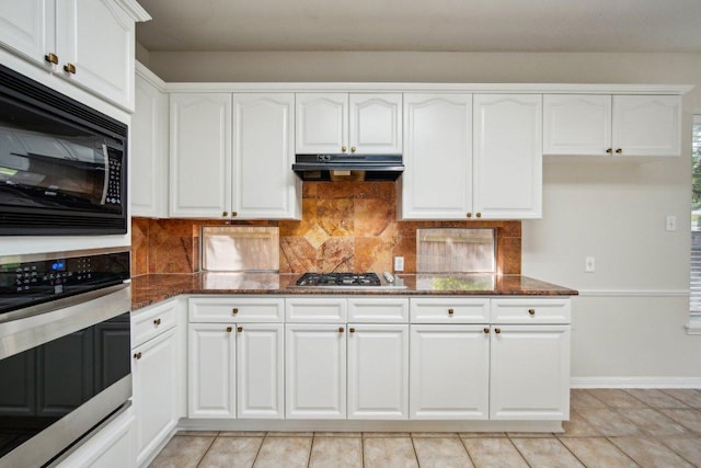5616 Gorham Glen Ln, Austin, TX 78739 - kitchen featuring appliances with stainless steel finishes, under cabinet range hood, dark stone counters, and white cabinets