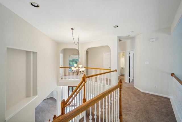 5616 Gorham Glen Ln, Austin, TX 78739 - corridor with an upstairs landing, carpet floors, a chandelier, arched walkways, and baseboards