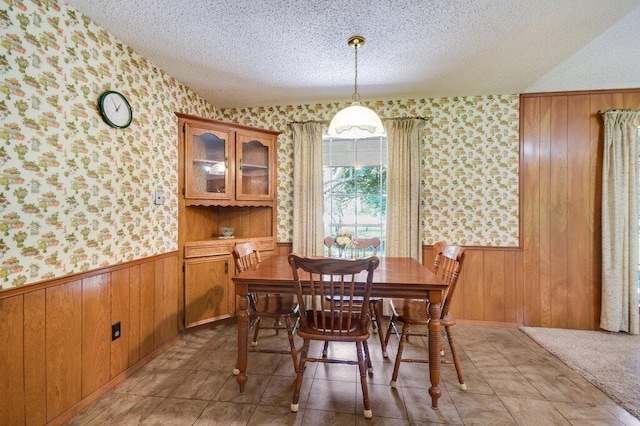 301 Navajo Trl, Georgetown, TX 78633 - dining space featuring wallpapered walls, a wainscoted wall, and a textured ceiling
