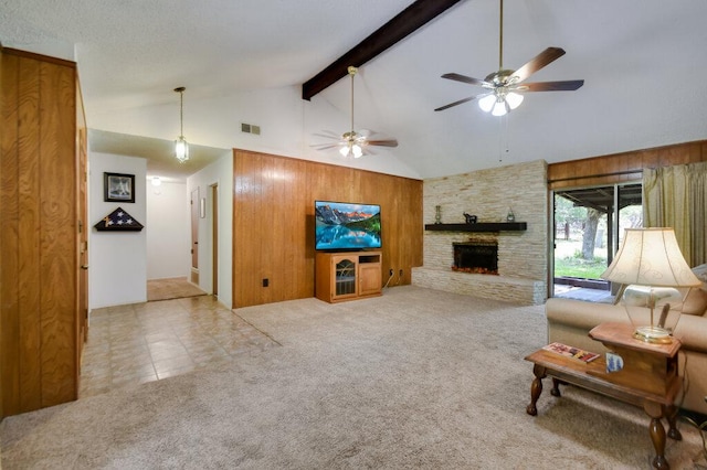 301 Navajo Trl, Georgetown, TX 78633 - carpeted living room with high vaulted ceiling, beam ceiling, a ceiling fan, a stone fireplace, and wood walls