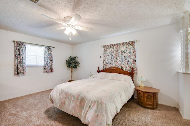 301 Navajo Trl, Georgetown, TX 78633 - bedroom with light colored carpet, a textured ceiling, and a ceiling fan
