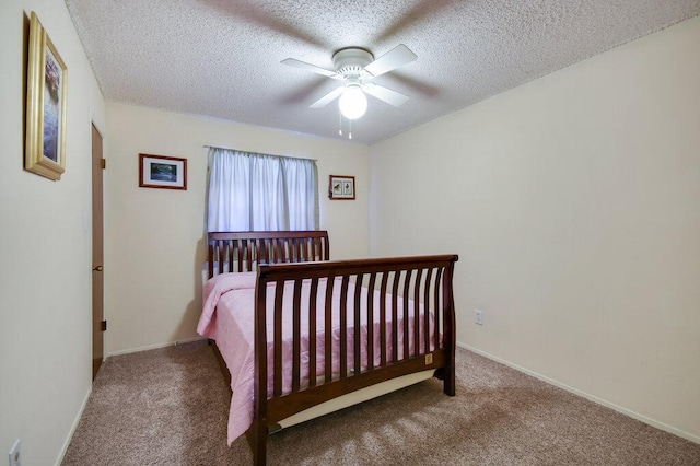 301 Navajo Trl, Georgetown, TX 78633 - carpeted bedroom with a textured ceiling, a ceiling fan, and baseboards
