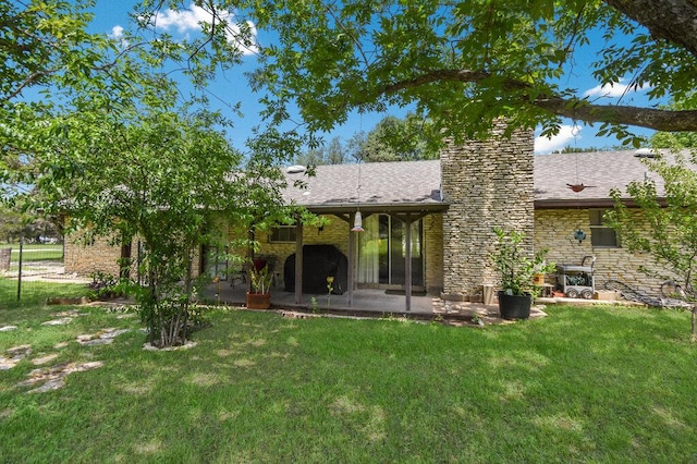 301 Navajo Trl, Georgetown, TX 78633 - back of house with a patio area, a yard, stone siding, and a chimney