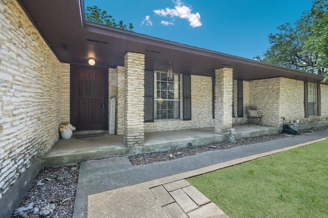 301 Navajo Trl, Georgetown, TX 78633 - property entrance featuring covered porch and stone siding