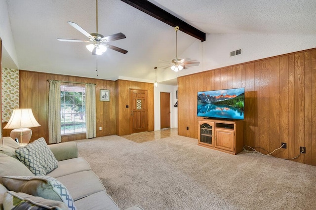 301 Navajo Trl, Georgetown, TX 78633 - living room featuring ceiling fan, wood walls, carpet floors, beam ceiling, and high vaulted ceiling
