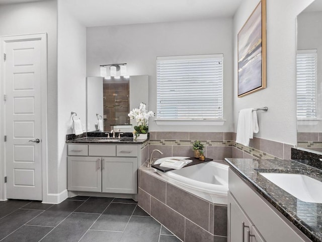116 Claiborne Lake Ln, Georgetown, TX 78628 - full bathroom featuring two vanities, tile patterned floors, a bath, and plenty of natural light