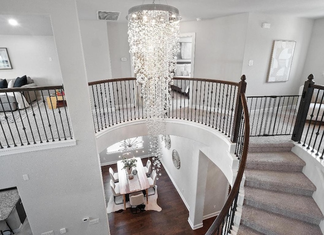 116 Claiborne Lake Ln, Georgetown, TX 78628 - stairs with a chandelier and wood finished floors