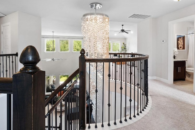 116 Claiborne Lake Ln, Georgetown, TX 78628 - stairway featuring a chandelier, carpet, and ceiling fan