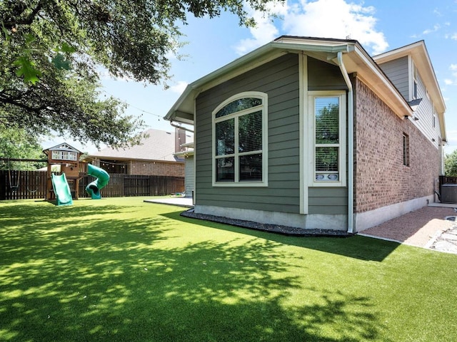 116 Claiborne Lake Ln, Georgetown, TX 78628 - view of property exterior featuring a playground and brick siding