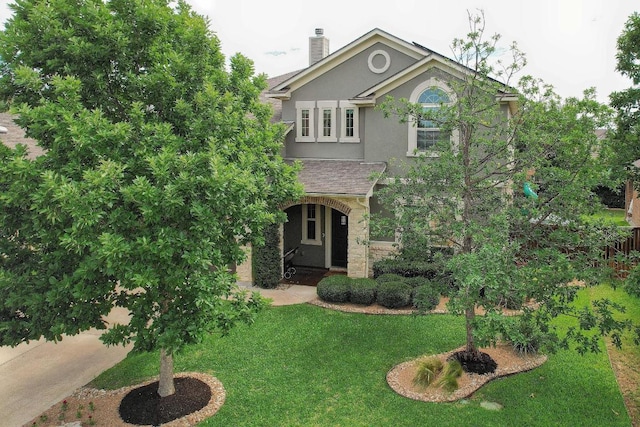 116 Claiborne Lake Ln, Georgetown, TX 78628 - view of front of property featuring stucco siding, a front yard, and a chimney