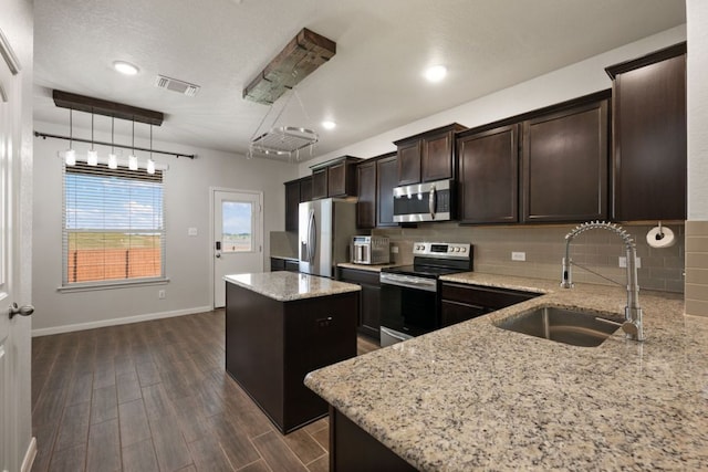 854 Pumpkin Rdg, New Braunfels, TX 78130 - kitchen with appliances with stainless steel finishes, a sink, a center island, backsplash, and dark wood-type flooring