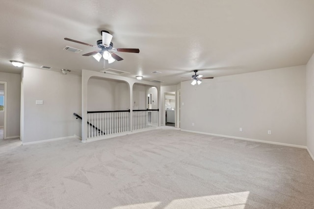 854 Pumpkin Rdg, New Braunfels, TX 78130 - empty room with a ceiling fan, light colored carpet, baseboards, and arched walkways