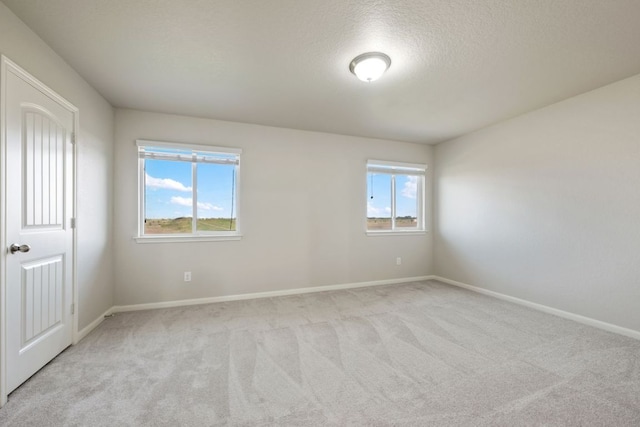854 Pumpkin Rdg, New Braunfels, TX 78130 - spare room featuring carpet floors, healthy amount of natural light, baseboards, and a textured ceiling
