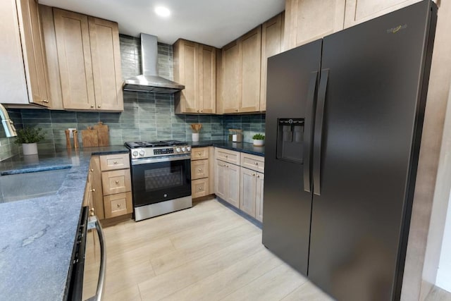 7702 Turquoise Trl, Austin, TX 78749 - kitchen featuring black fridge, gas stove, wall chimney range hood, a sink, and tasteful backsplash