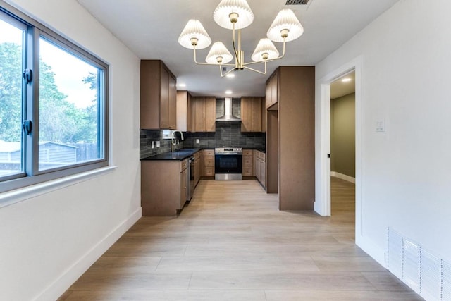 7702 Turquoise Trl, Austin, TX 78749 - kitchen with stainless steel appliances, wall chimney exhaust hood, healthy amount of natural light, and dark countertops