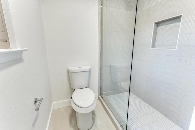 7702 Turquoise Trl, Austin, TX 78749 - full bath with toilet, a walk in shower, baseboards, and tile patterned floors
