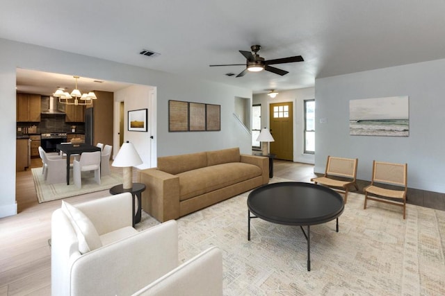 7702 Turquoise Trl, Austin, TX 78749 - living area featuring a chandelier, light wood-type flooring, and ceiling fan