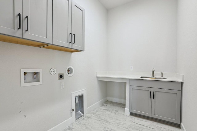16825 Roselin Dr, Austin, TX 78738 - laundry area with gas dryer hookup, cabinet space, electric dryer hookup, baseboards, and light marble finish flooring