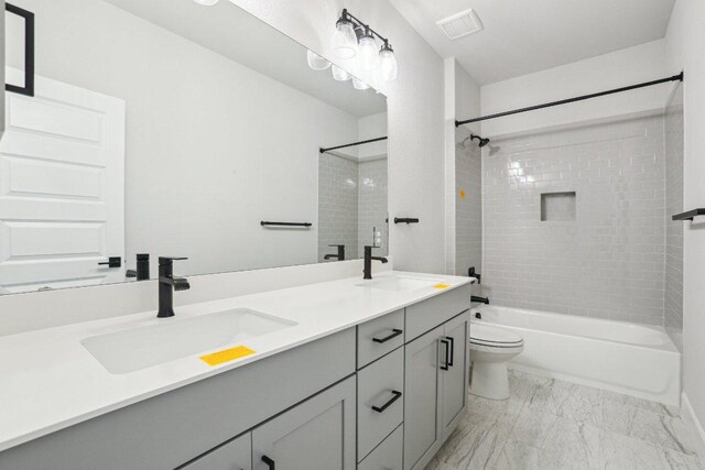 16825 Roselin Dr, Austin, TX 78738 - bathroom featuring double vanity, washtub / shower combination, marble look tiles, and toilet