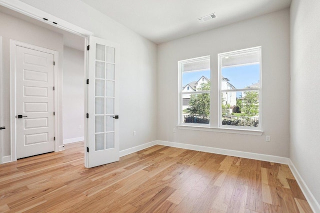 16825 Roselin Dr, Austin, TX 78738 - spare room featuring light wood finished floors, french doors, and baseboards