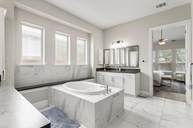 1504 Saddlespur Ln, Leander, TX 78641 - bathroom with marble look tile flooring, a bath, vanity, ensuite bathroom, and a ceiling fan