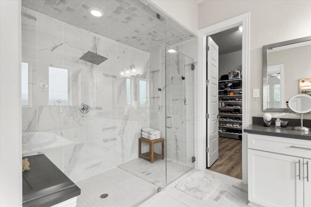 1504 Saddlespur Ln, Leander, TX 78641 - bathroom featuring a marble finish shower, vanity, marble finish floors, and a spacious closet