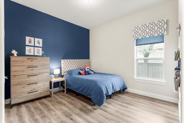 1504 Saddlespur Ln, Leander, TX 78641 - bedroom with wood finished floors, baseboards, and vaulted ceiling