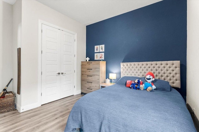 1504 Saddlespur Ln, Leander, TX 78641 - bedroom featuring wood finished floors and a closet