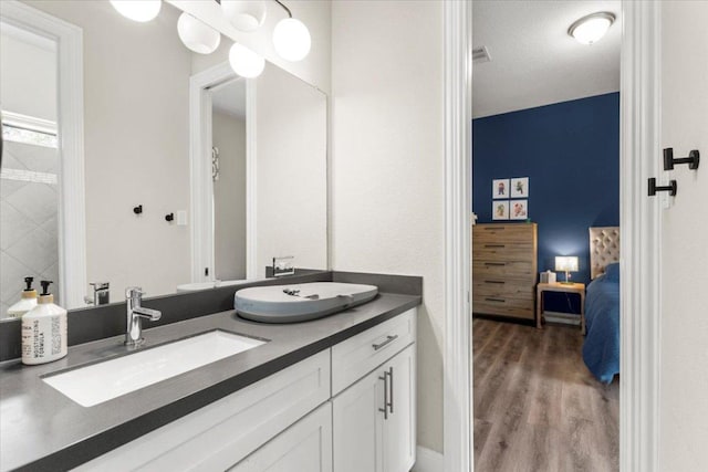1504 Saddlespur Ln, Leander, TX 78641 - full bath featuring double vanity, wood finished floors, and ensuite bath