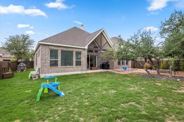 1504 Saddlespur Ln, Leander, TX 78641 - back of house featuring brick siding, a fenced backyard, a patio area, a chimney, and roof with shingles