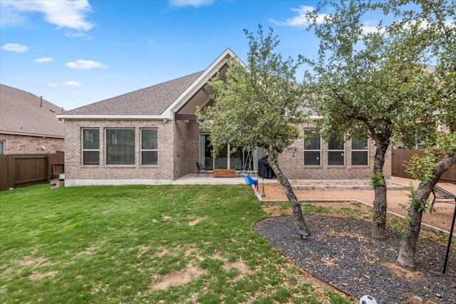 1504 Saddlespur Ln, Leander, TX 78641 - rear view of property with brick siding, a fenced backyard, and a patio