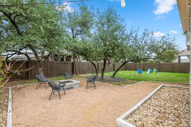 1504 Saddlespur Ln, Leander, TX 78641 - fenced backyard featuring an outdoor fire pit and a playground