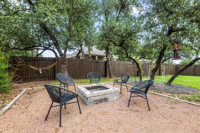 1504 Saddlespur Ln, Leander, TX 78641 - fenced backyard featuring an outdoor fire pit