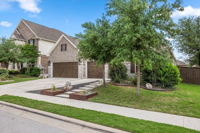 1504 Saddlespur Ln, Leander, TX 78641 - view of front facade with concrete driveway, an attached garage, and brick siding