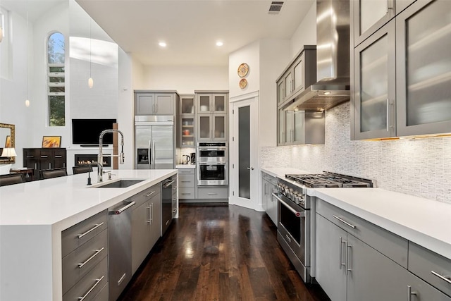 104 Sendera Bonita, Lakeway, TX 78734 - kitchen featuring wall chimney exhaust hood, stainless steel appliances, gray cabinetry, light countertops, and recessed lighting