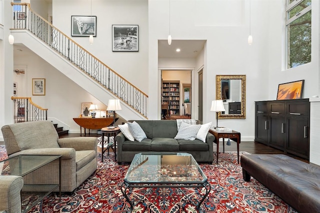 104 Sendera Bonita, Lakeway, TX 78734 - living room featuring a towering ceiling, stairway, and dark wood-style floors