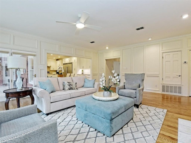 203 Wallis Dr, Austin, TX 78746 - living area with a decorative wall, ornamental molding, light wood-style flooring, ceiling fan, and recessed lighting