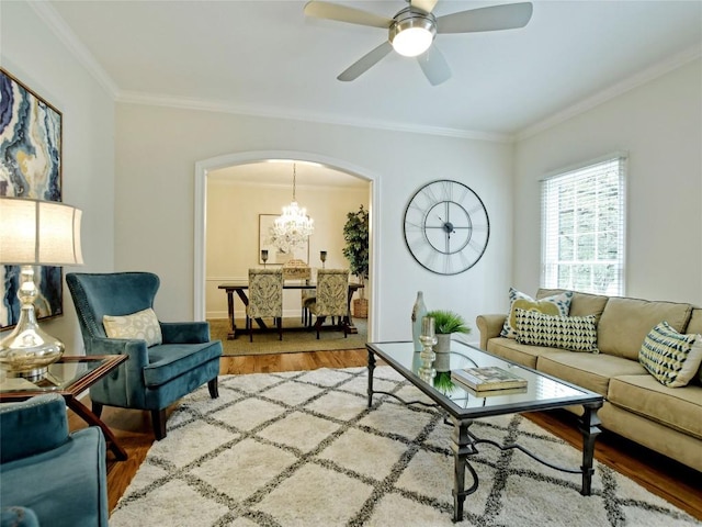 203 Wallis Dr, Austin, TX 78746 - living room featuring wood finished floors, crown molding, arched walkways, ceiling fan, and a chandelier