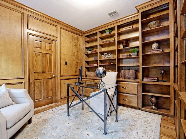 203 Wallis Dr, Austin, TX 78746 - office area featuring light wood-style flooring, built in features, and wooden walls