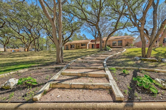 2804 Rock Way, Austin, TX 78746 - view of front of house featuring brick siding and a front lawn