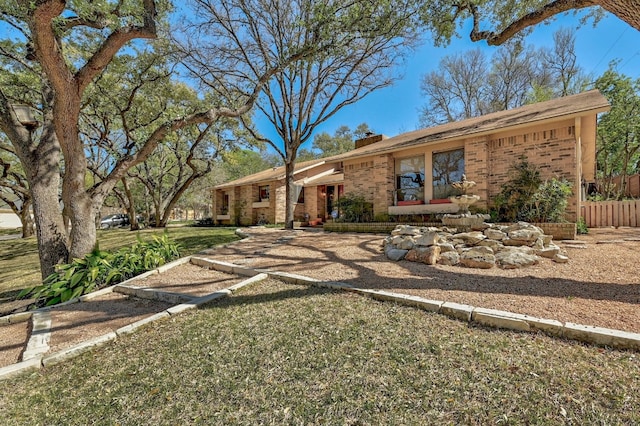 2804 Rock Way, Austin, TX 78746 - ranch-style home featuring brick siding, a chimney, and a front yard