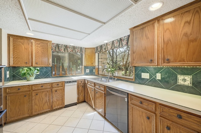 2804 Rock Way, Austin, TX 78746 - kitchen with stainless steel dishwasher, a sink, brown cabinetry, backsplash, and light countertops