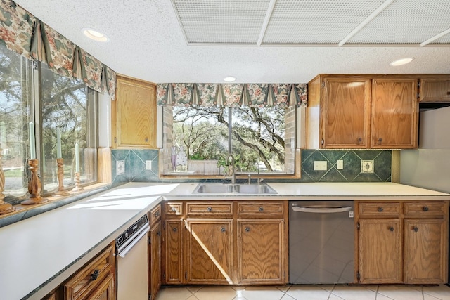 2804 Rock Way, Austin, TX 78746 - kitchen with dishwasher, a sink, light countertops, tasteful backsplash, and a textured ceiling