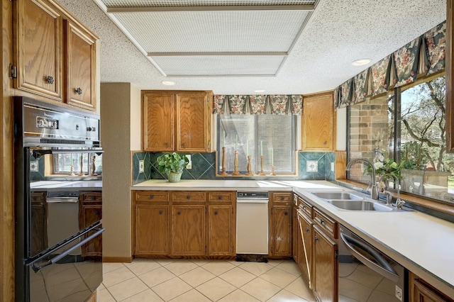 2804 Rock Way, Austin, TX 78746 - kitchen with stainless steel dishwasher, a sink, brown cabinetry, and decorative backsplash