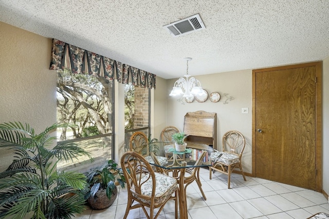 2804 Rock Way, Austin, TX 78746 - dining area with a chandelier, a textured ceiling, light tile patterned floors, and a textured wall