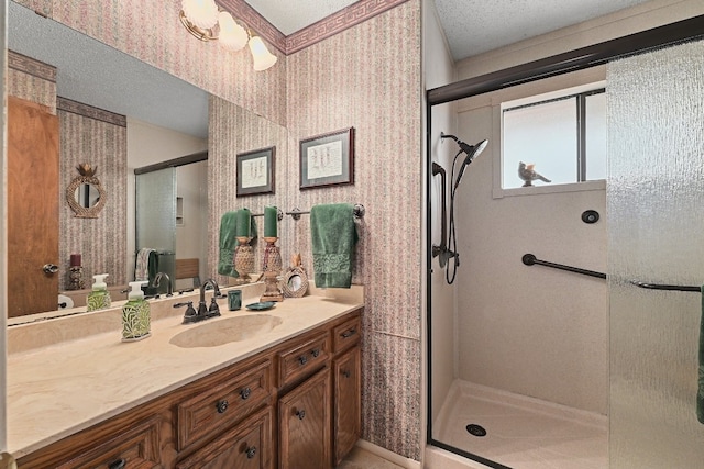 2804 Rock Way, Austin, TX 78746 - bathroom featuring wallpapered walls, a stall shower, vanity, and a textured ceiling
