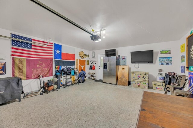 116 Bufflehead, Leander, TX 78641 - garage featuring stainless steel fridge and a garage door opener