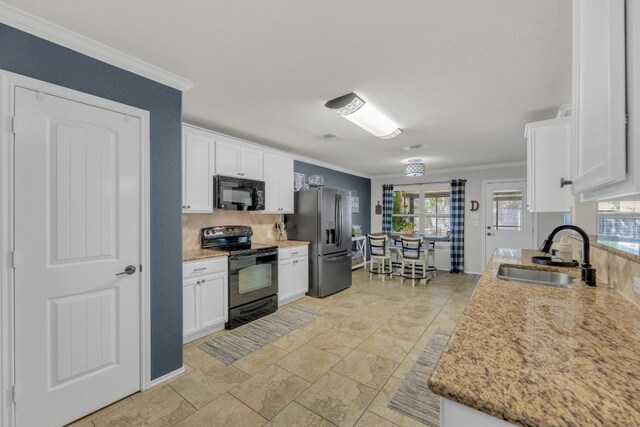 116 Bufflehead, Leander, TX 78641 - kitchen featuring black appliances, a sink, ornamental molding, white cabinetry, and decorative backsplash