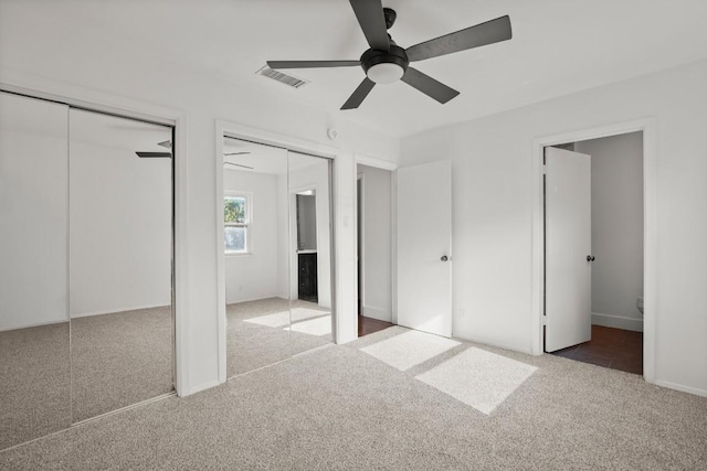 5706 Cherry Park, Austin, TX 78745 - unfurnished bedroom with carpet flooring, multiple closets, ceiling fan, and baseboards