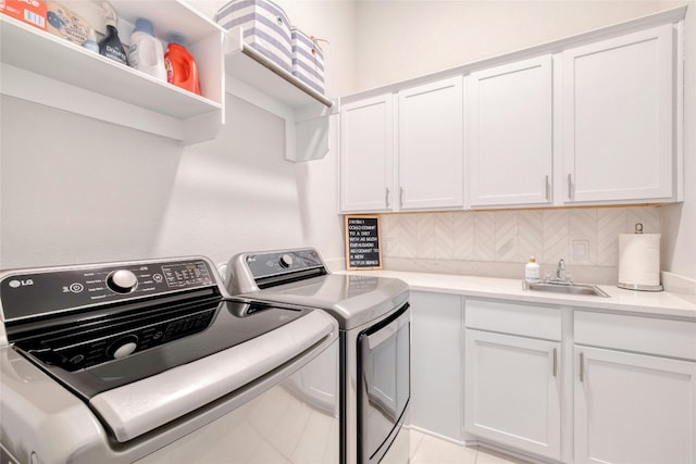 108 Windgate Dr, Hutto, TX 78634 - laundry room featuring independent washer and dryer and cabinet space
